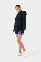 Girl Wearing Black Hoodie and Purple Shorts