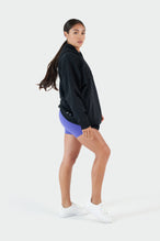 Girl Wearing Black Hoodie and Purple Shorts