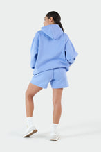 Girl Wearing Periwinkle Hoodie and Shorts