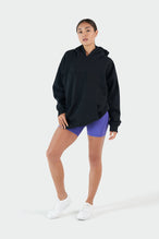 Girl Wearing Black Hoodie and Purple Shorts